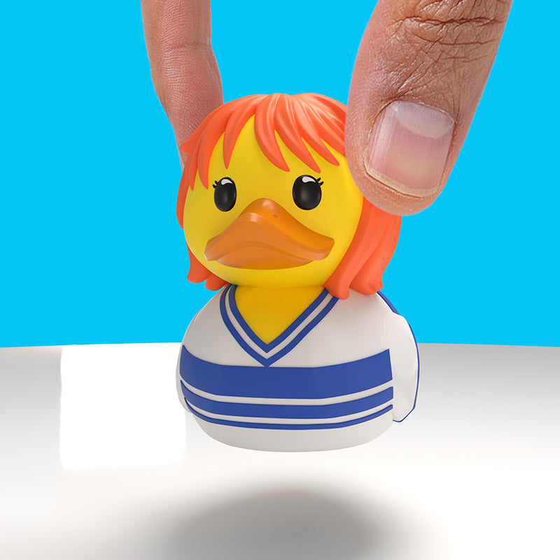Nami Mini TUBBZ held between two fingers in an official scale photograph.